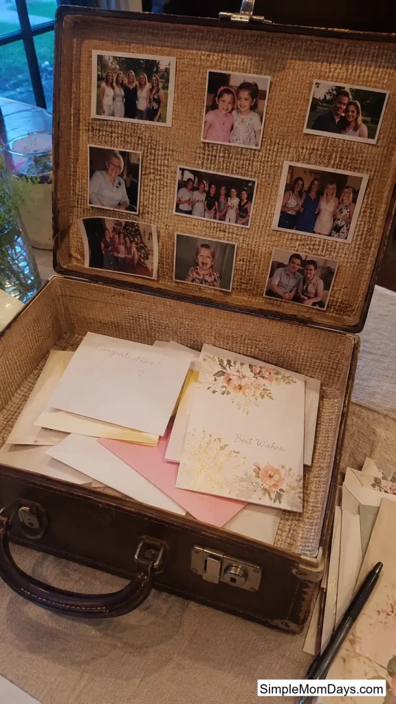 A Suitcase Lined With Photos as the Card Station